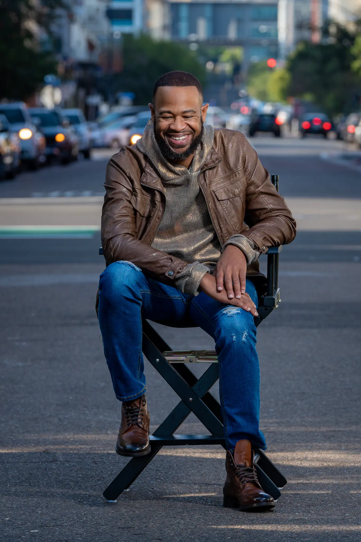 DeWayne Woods on director's chair in street