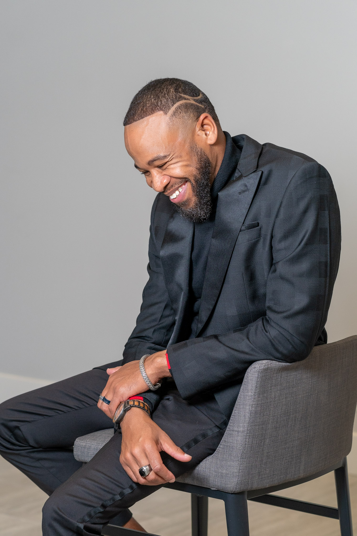 DeWayne Woods in black suit smiling